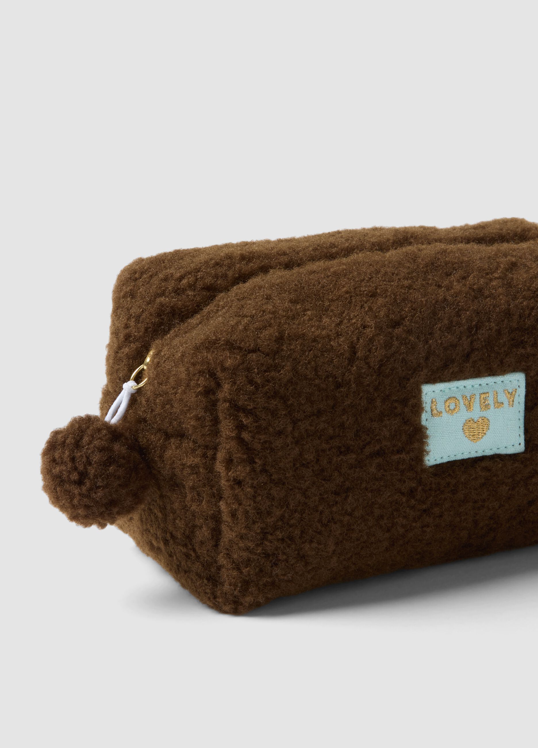 Brown beauty case with pompom