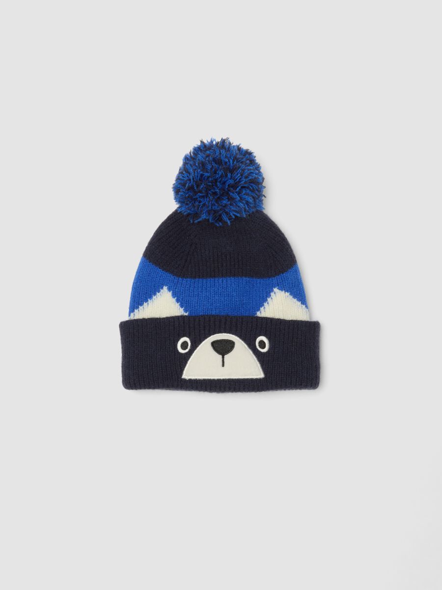 Blue knitted hat with pom-pom and animal motif_0