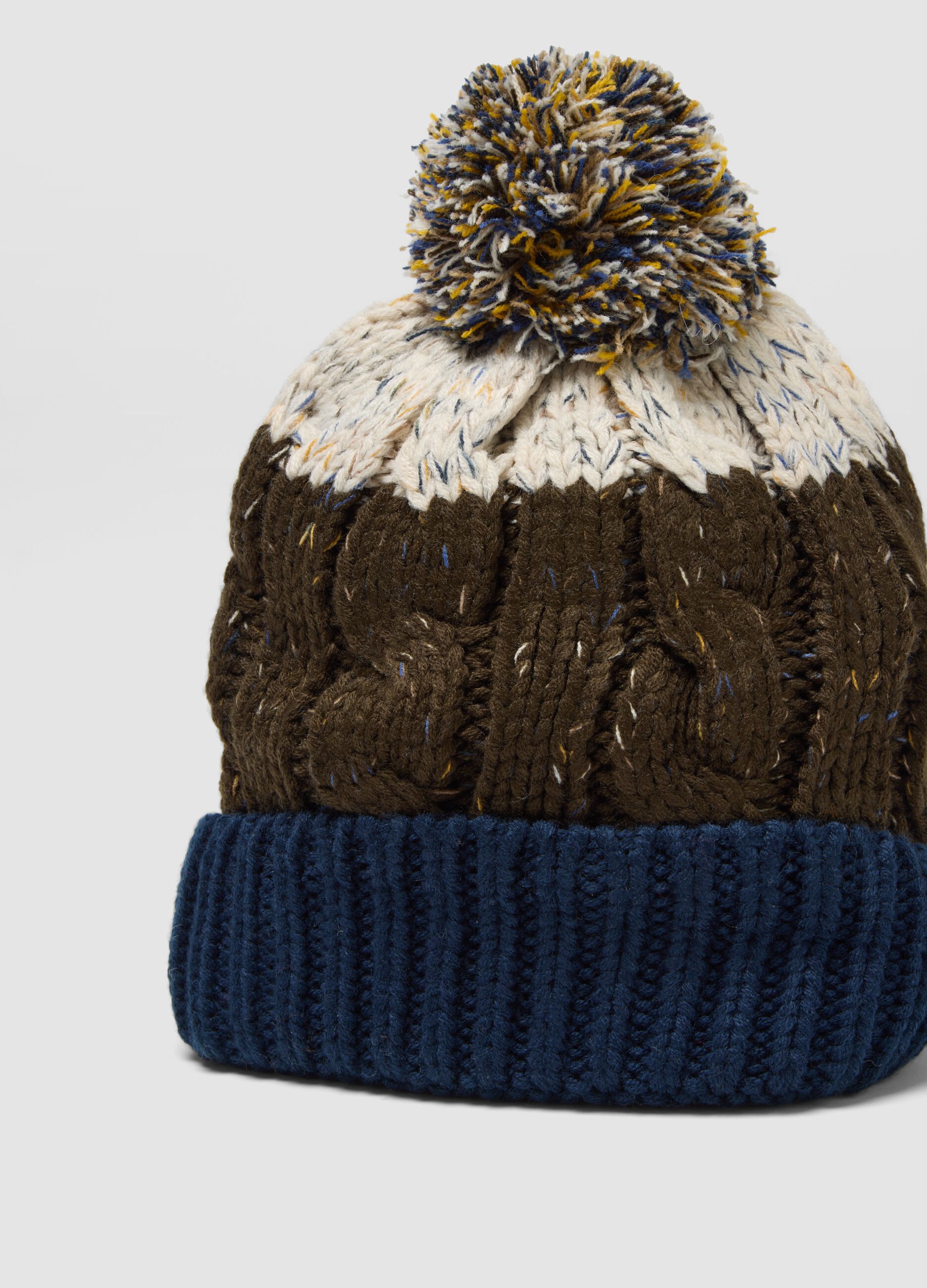 Blue and brown knitted beanie with pom-pom