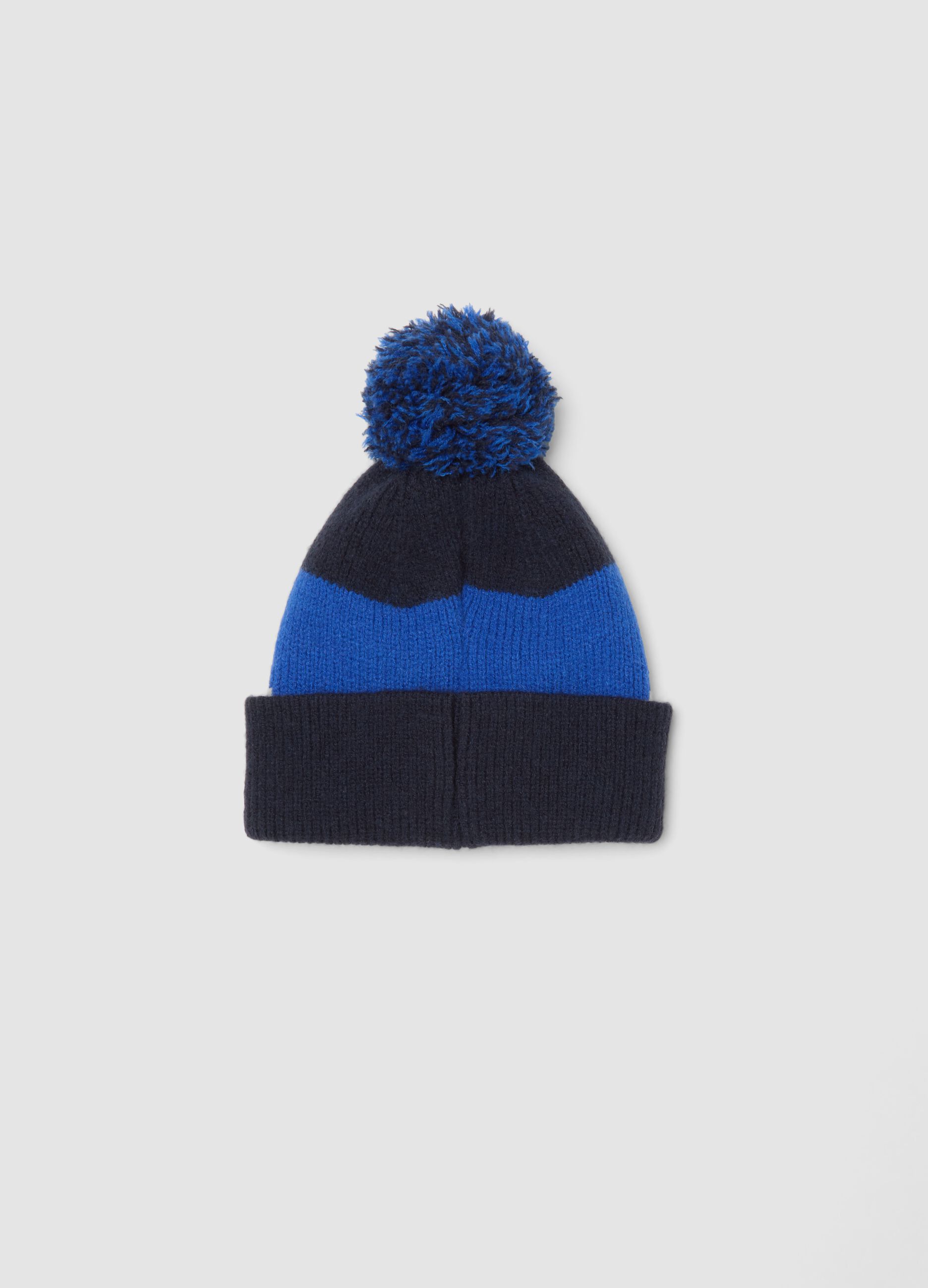 Blue knitted hat with pom-pom and animal motif