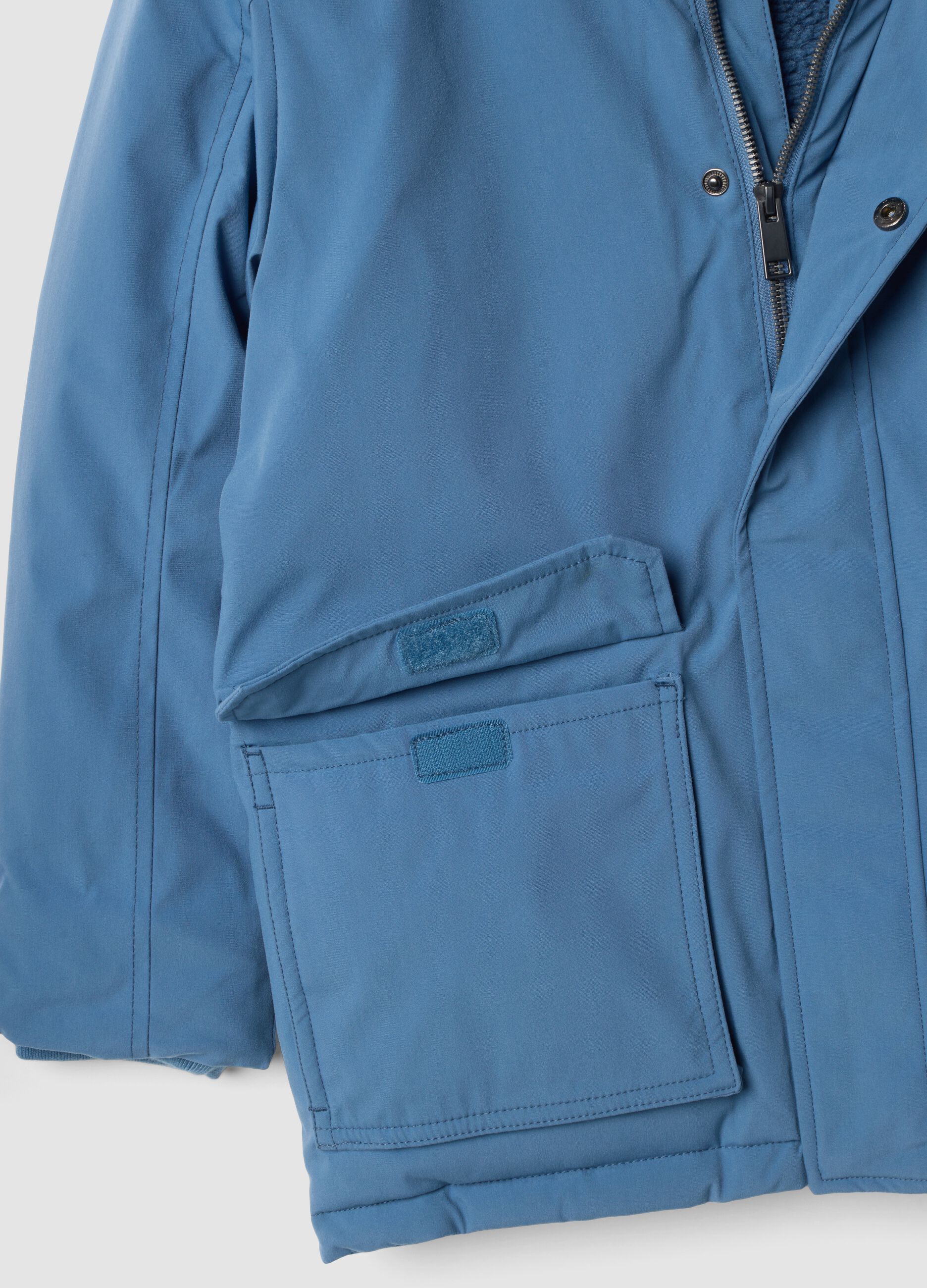Long padded blue parka with detachable hood, oversized fit