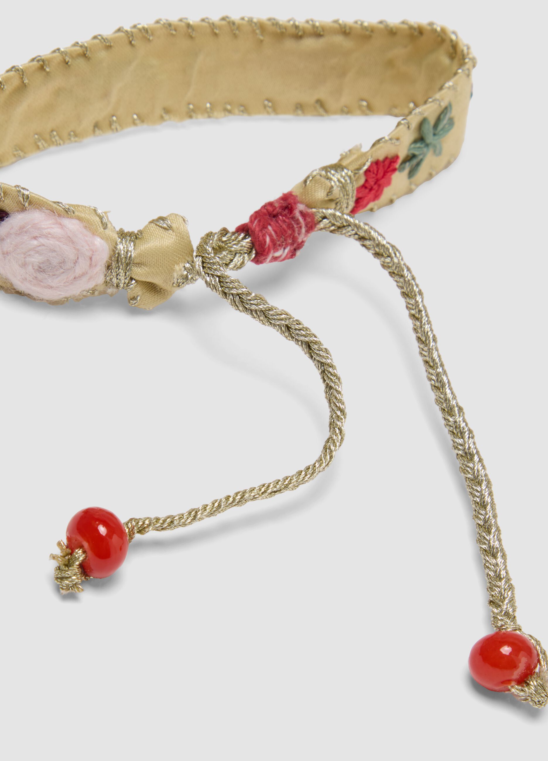 Beige embroidered bracelet with adjustable tie cords