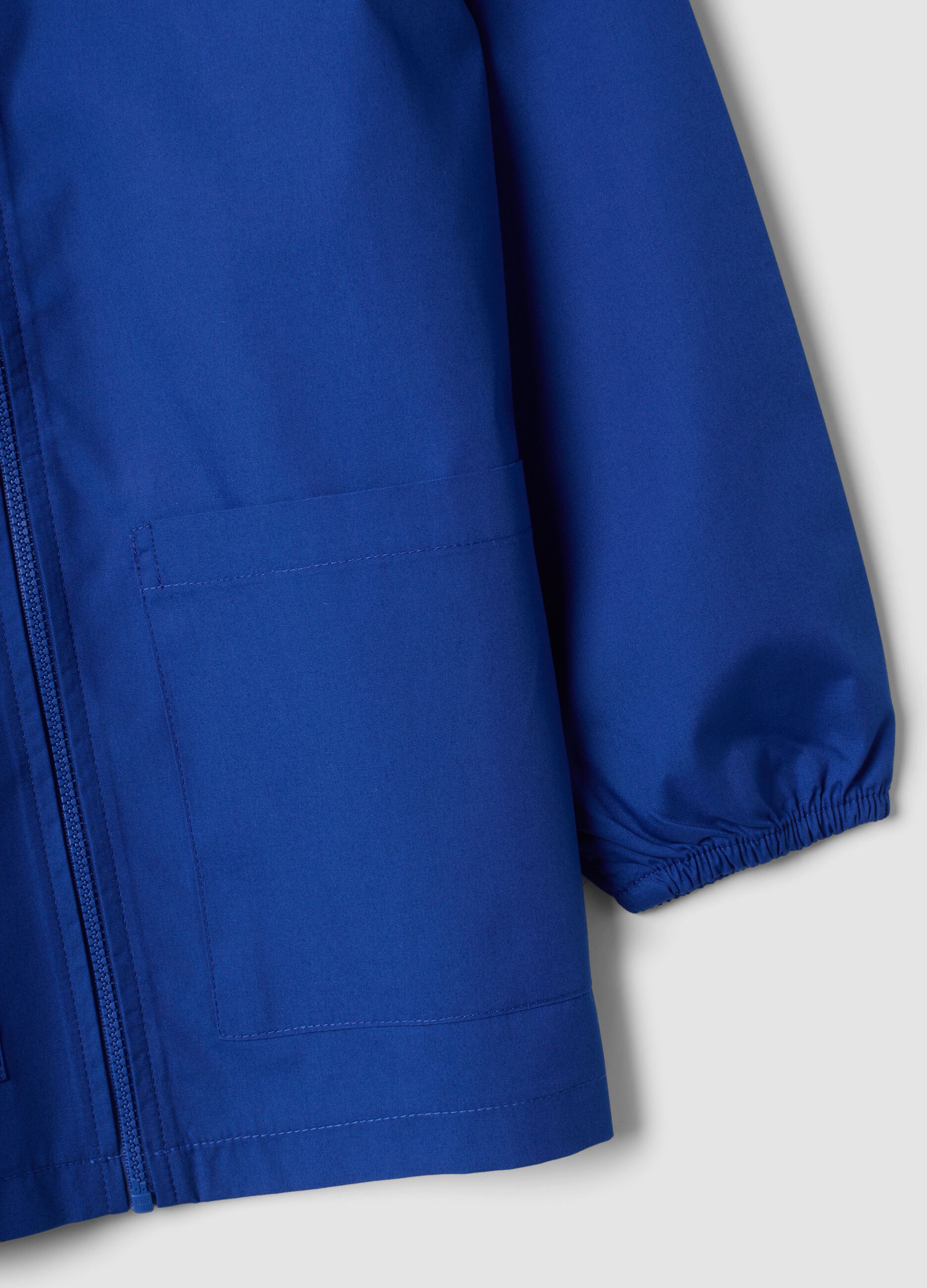 Customisable blue school apron with zip and go-kart embroidery for boys