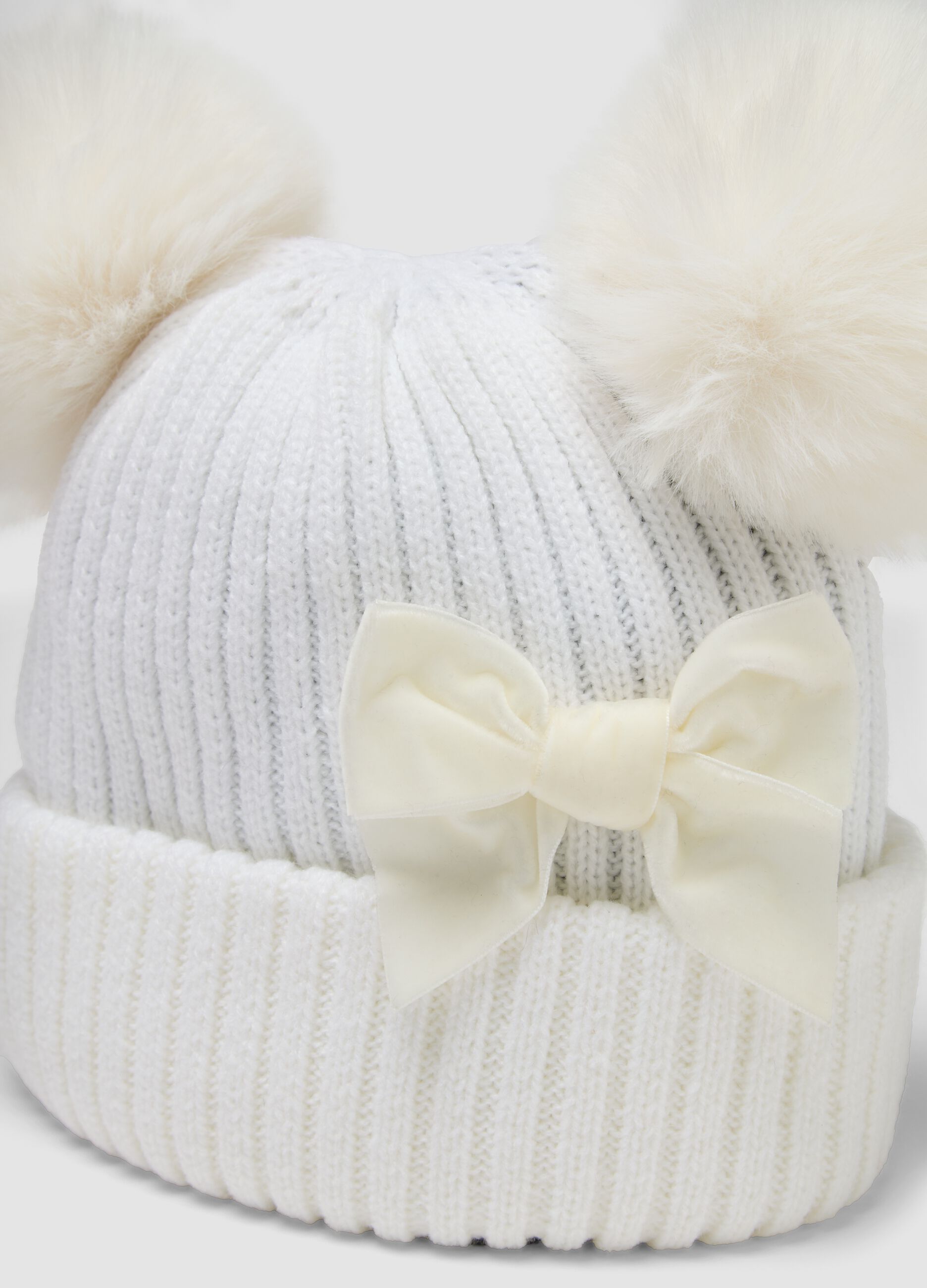 White rib-knit hat with bow and pom-poms