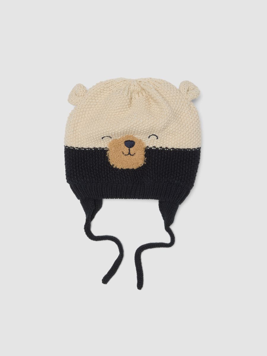 Blue knitted hat with teddy bear motif and ties_0