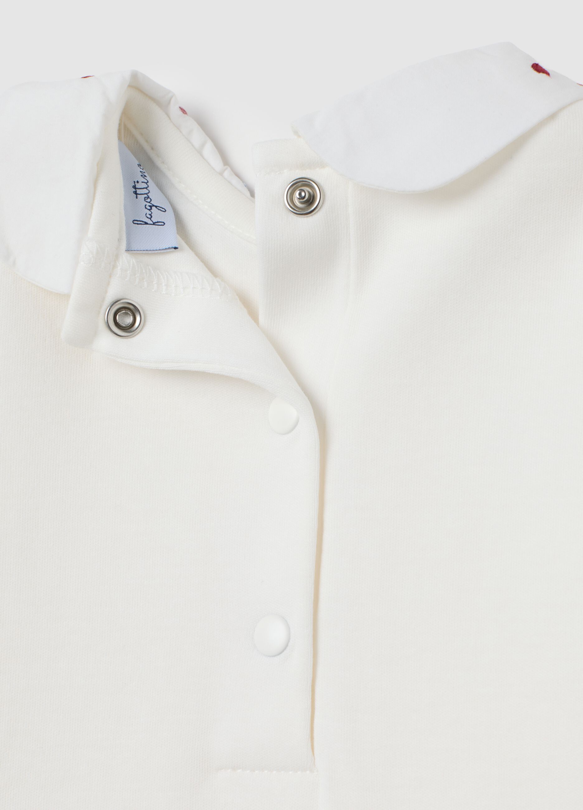 Newborn baby bodysuit in pure white cotton with ruffled collar