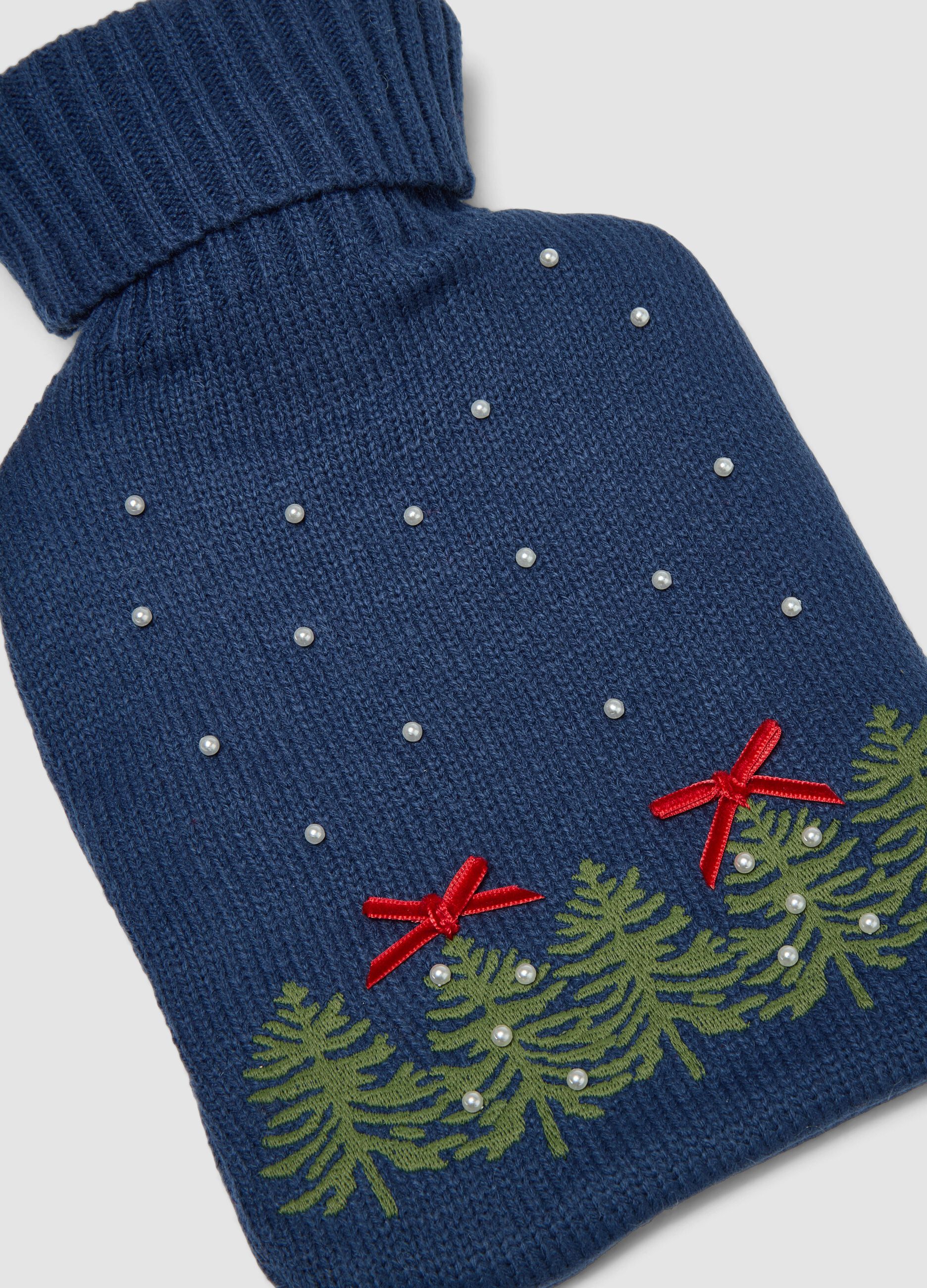 Blue hot water bottle with knitted cover