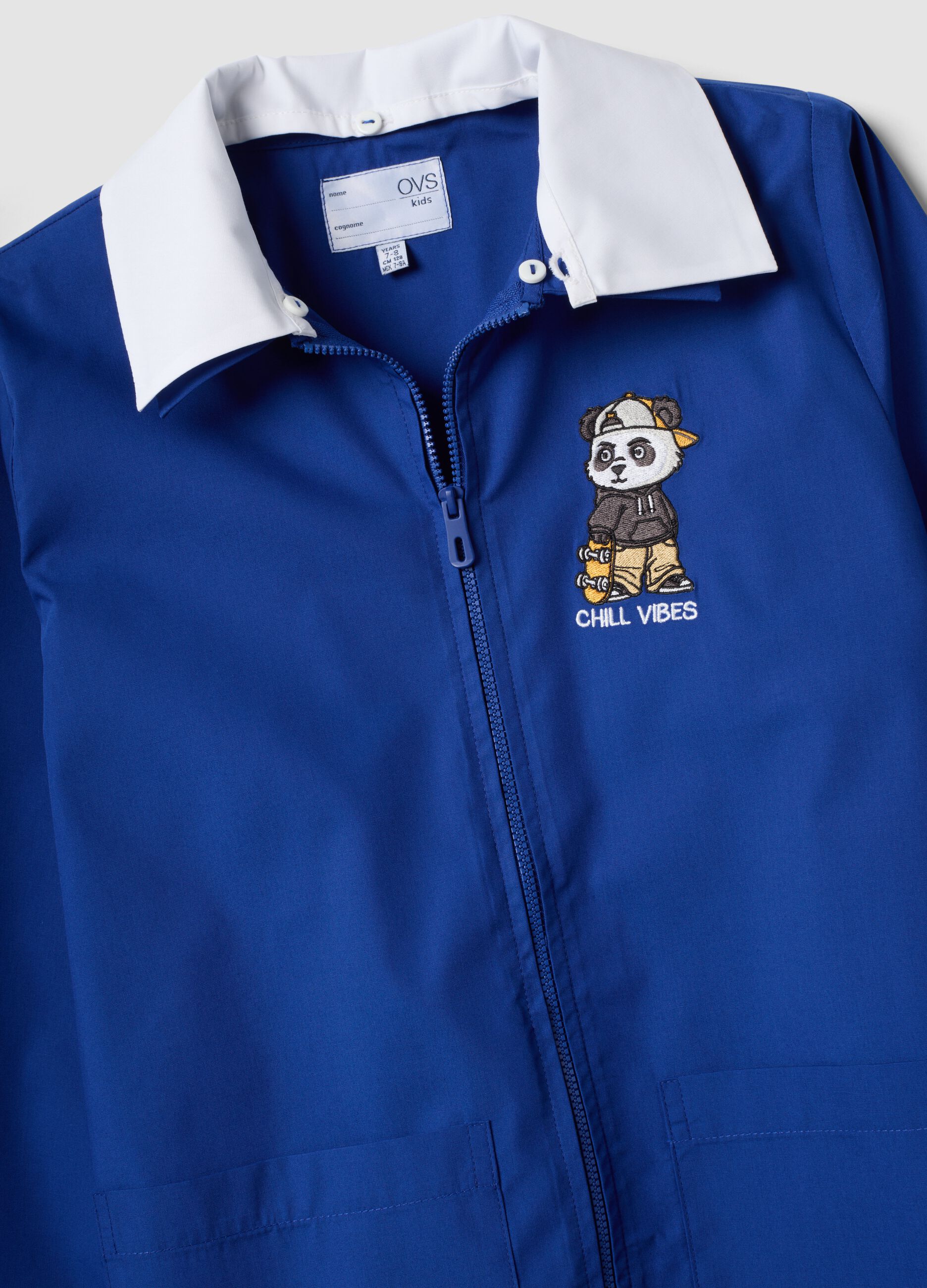 Customisable blue school apron with zip and panda embroidery