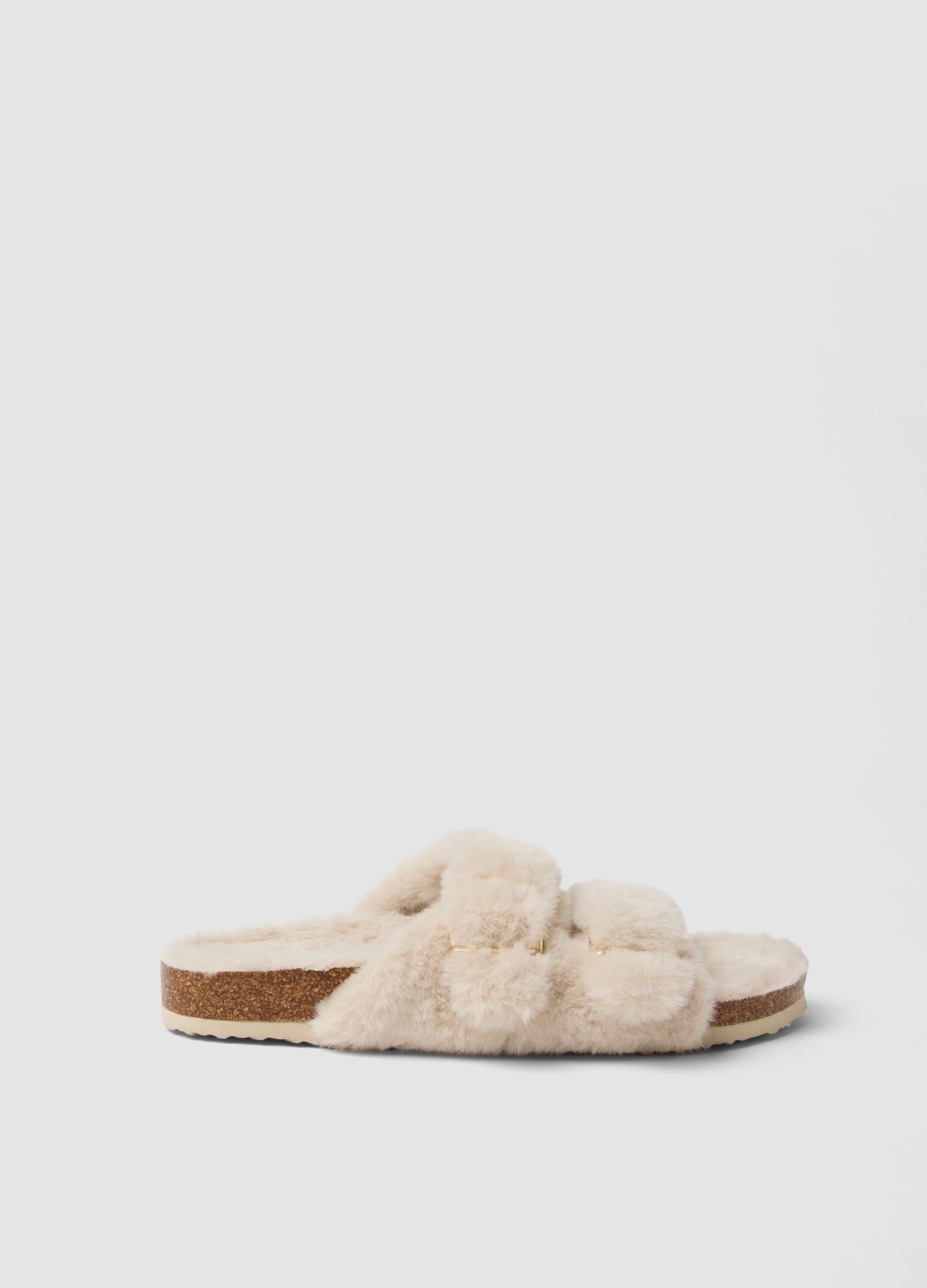 Beige open-toe slippers with crossed straps and buckle