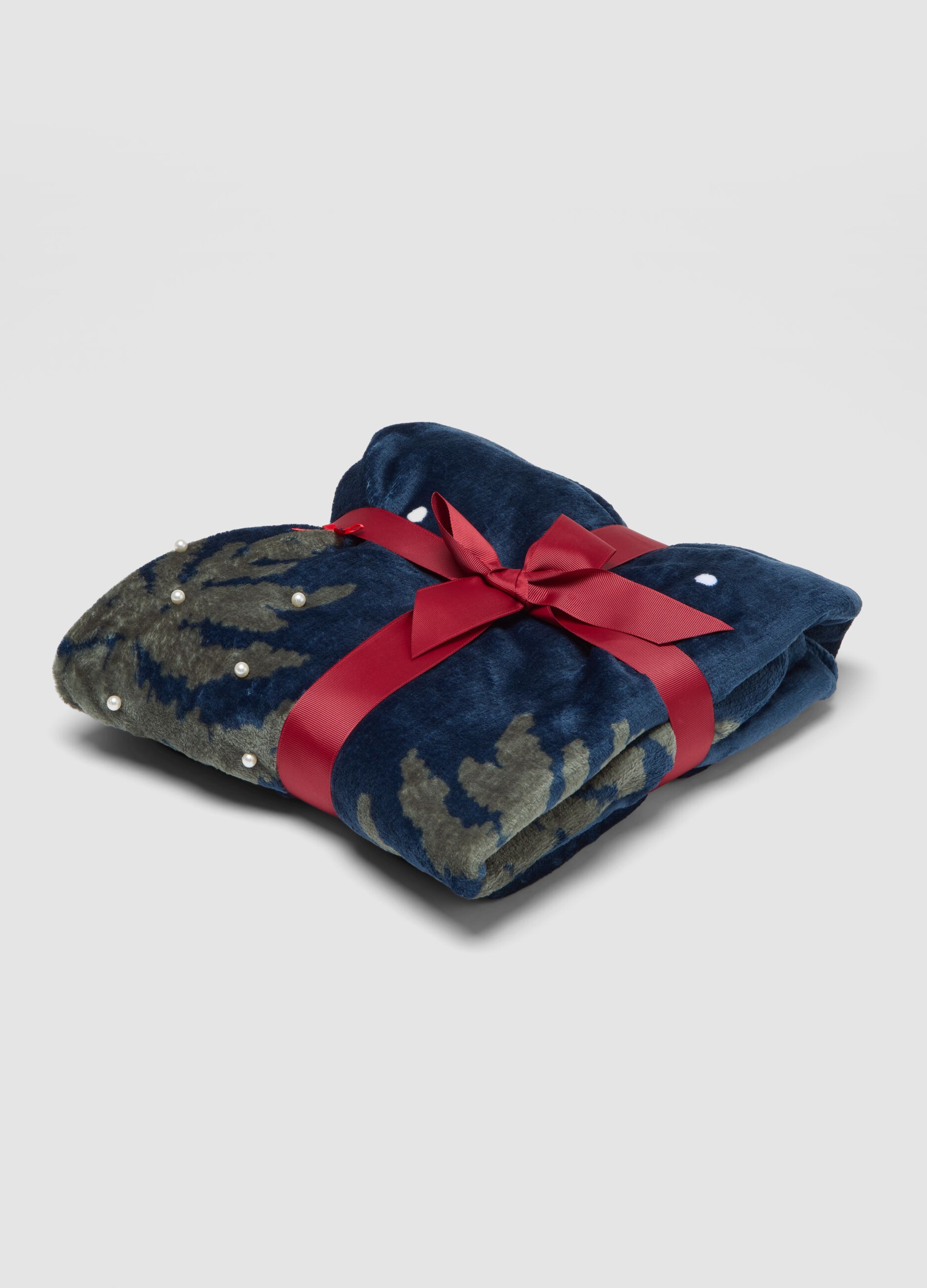 Blue and green throw with tree and polka-dot pattern