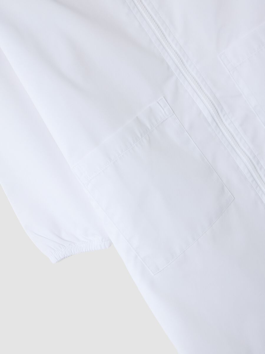 Customisable white nursery apron with zip and dinosaur embroidery_3