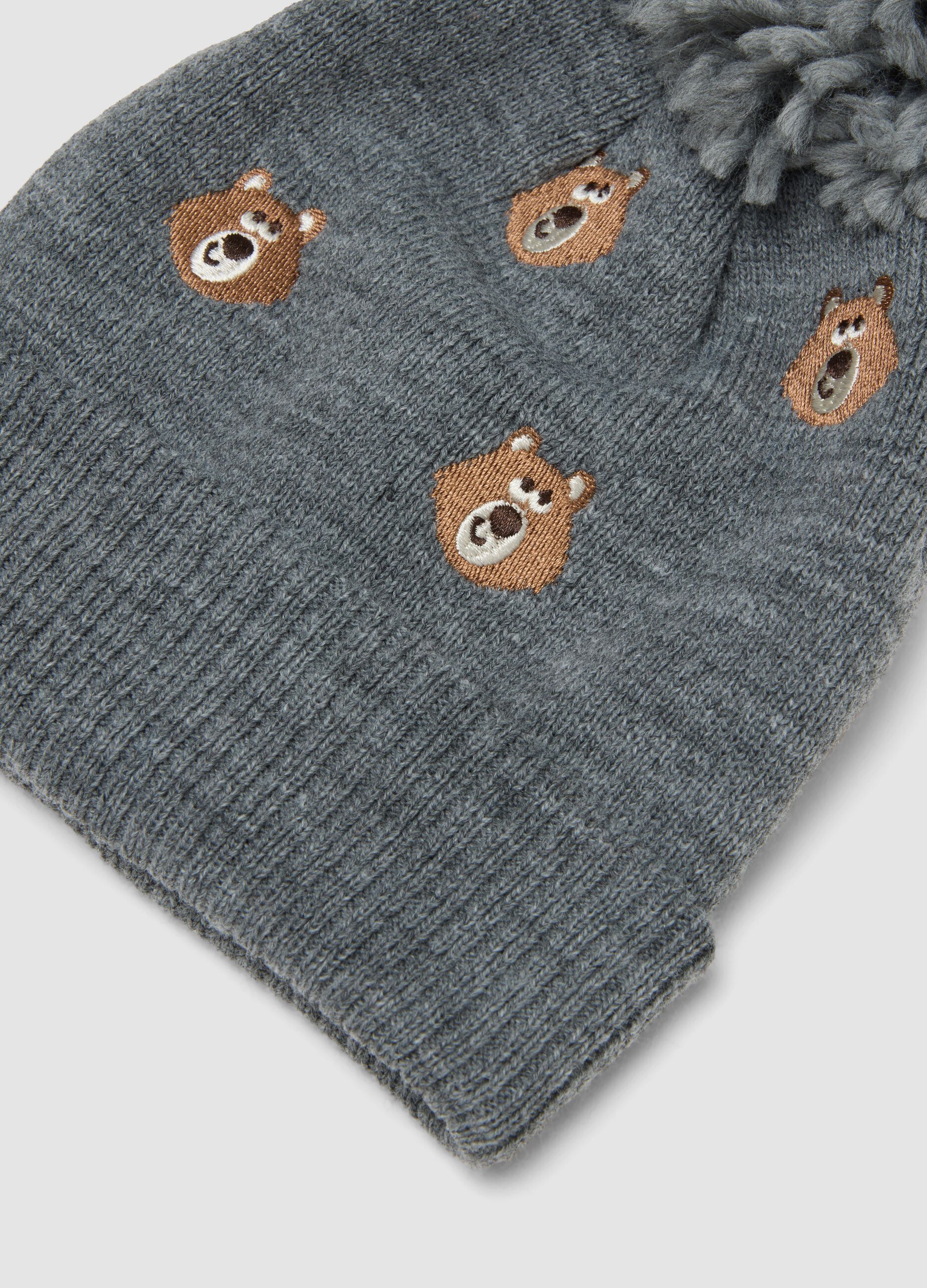 Grey knitted hat with pom pom and teddy bear pattern
