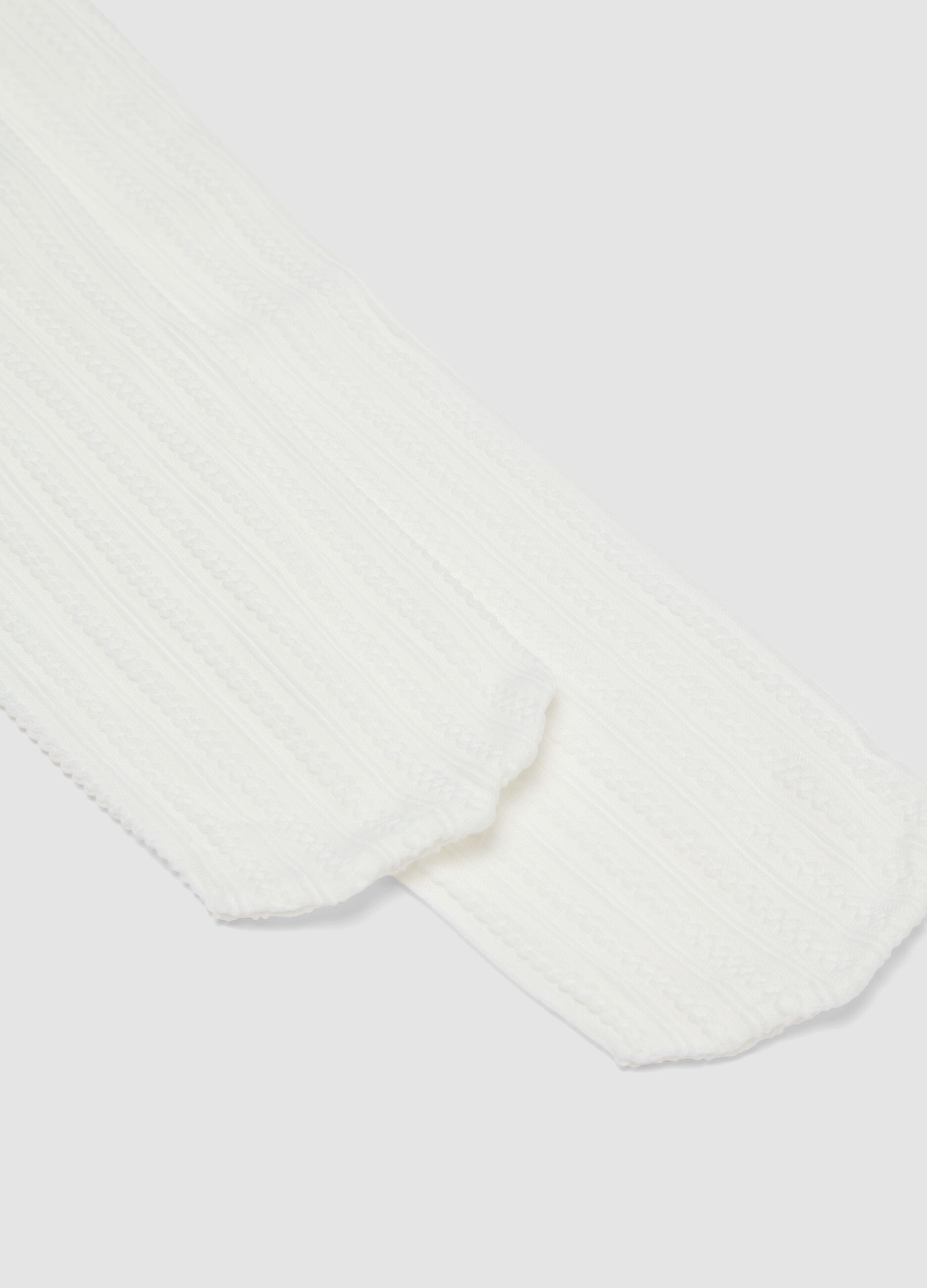 Collant bianco in tessuto elasticizzato con motivo lavorato