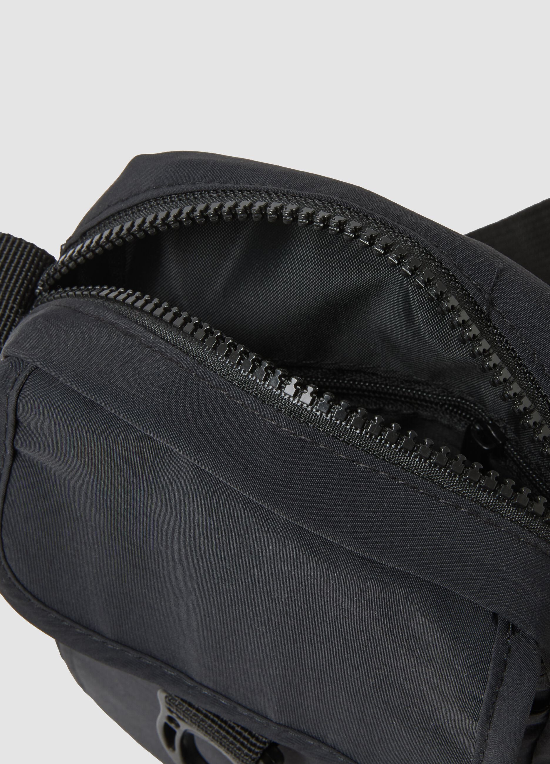 Black crossbody bag with zip closure and adjustable strap