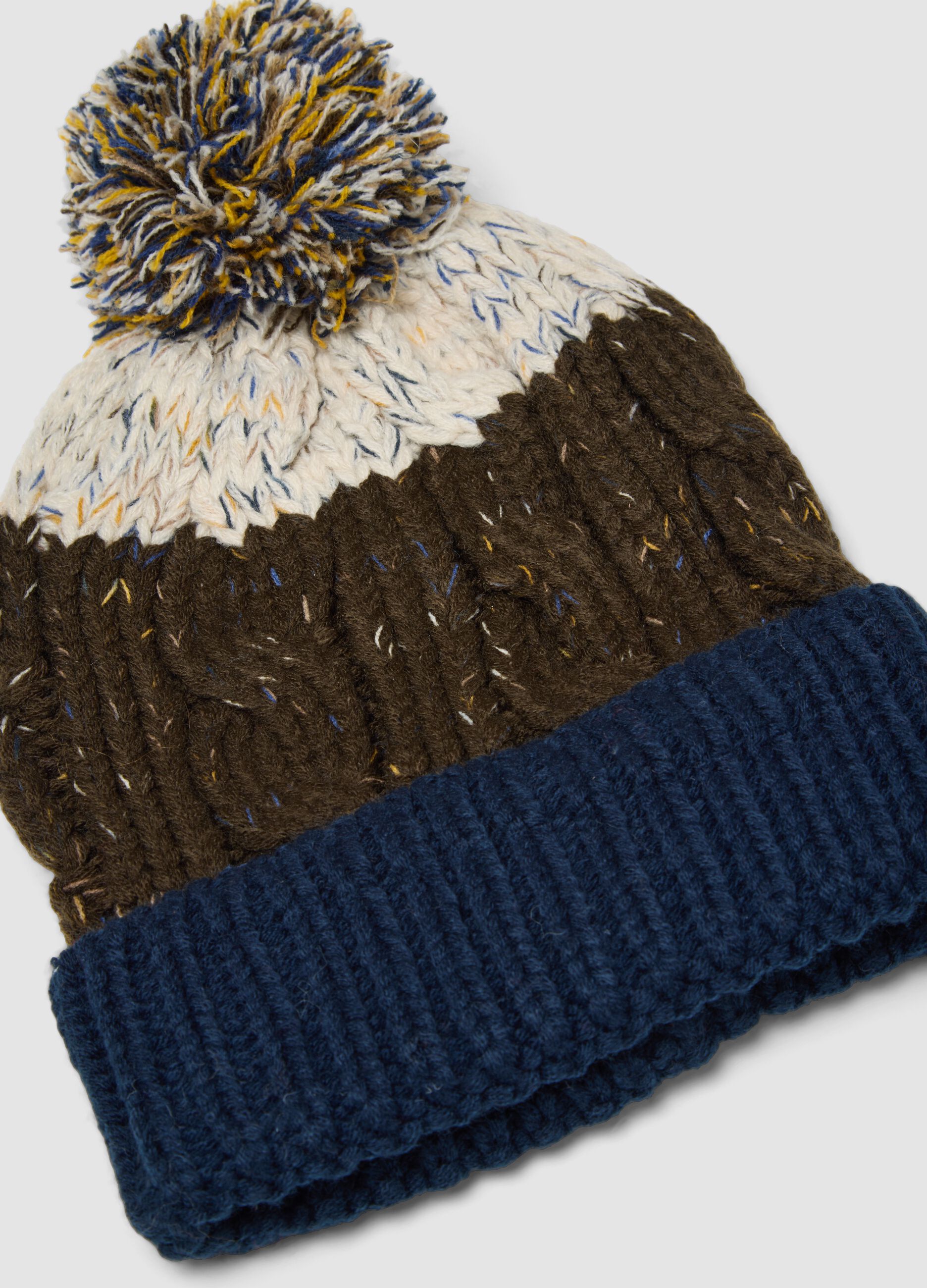 Blue and brown knitted beanie with pom-pom