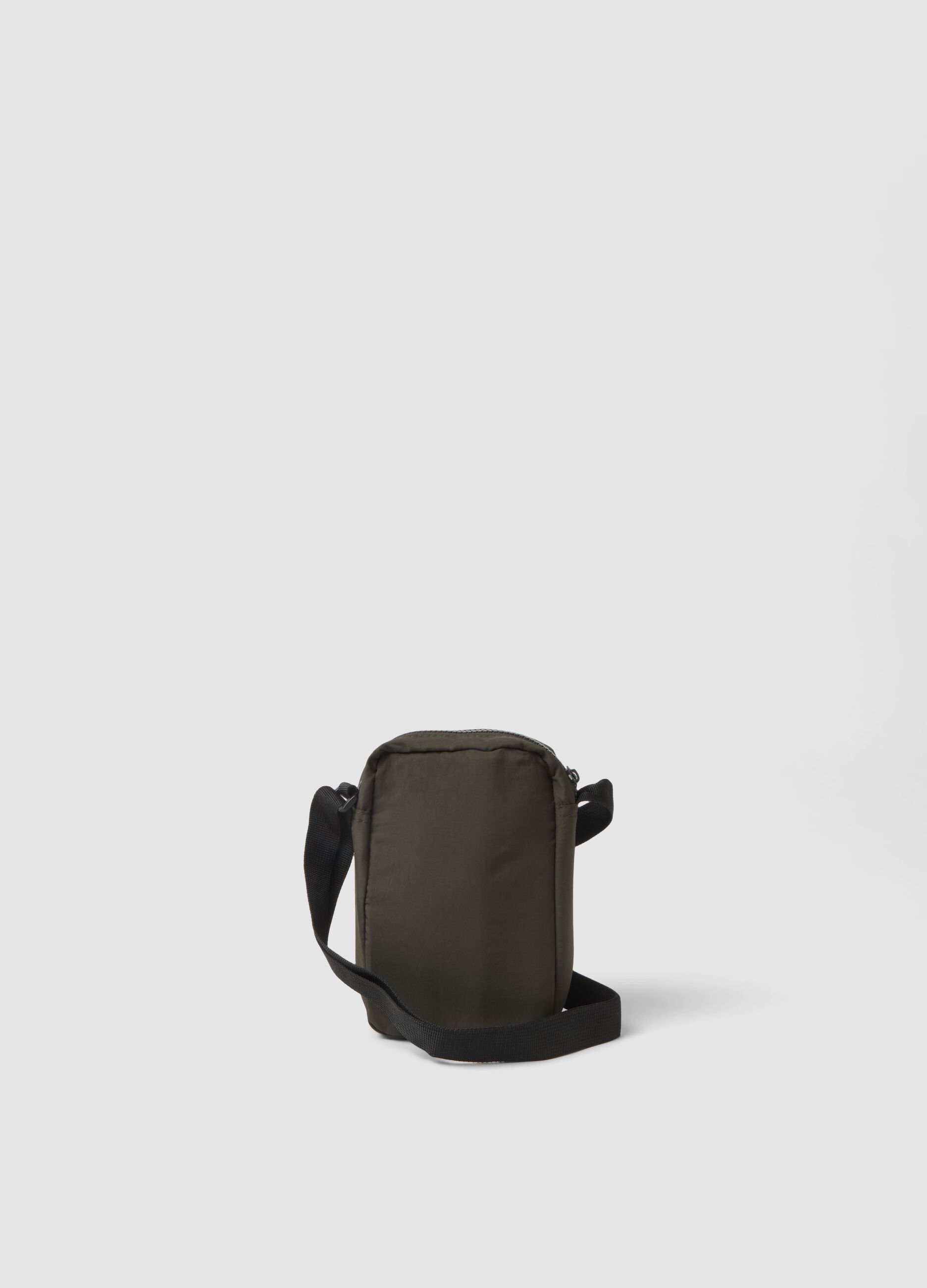 Green crossbody bag with zip closure and adjustable strap