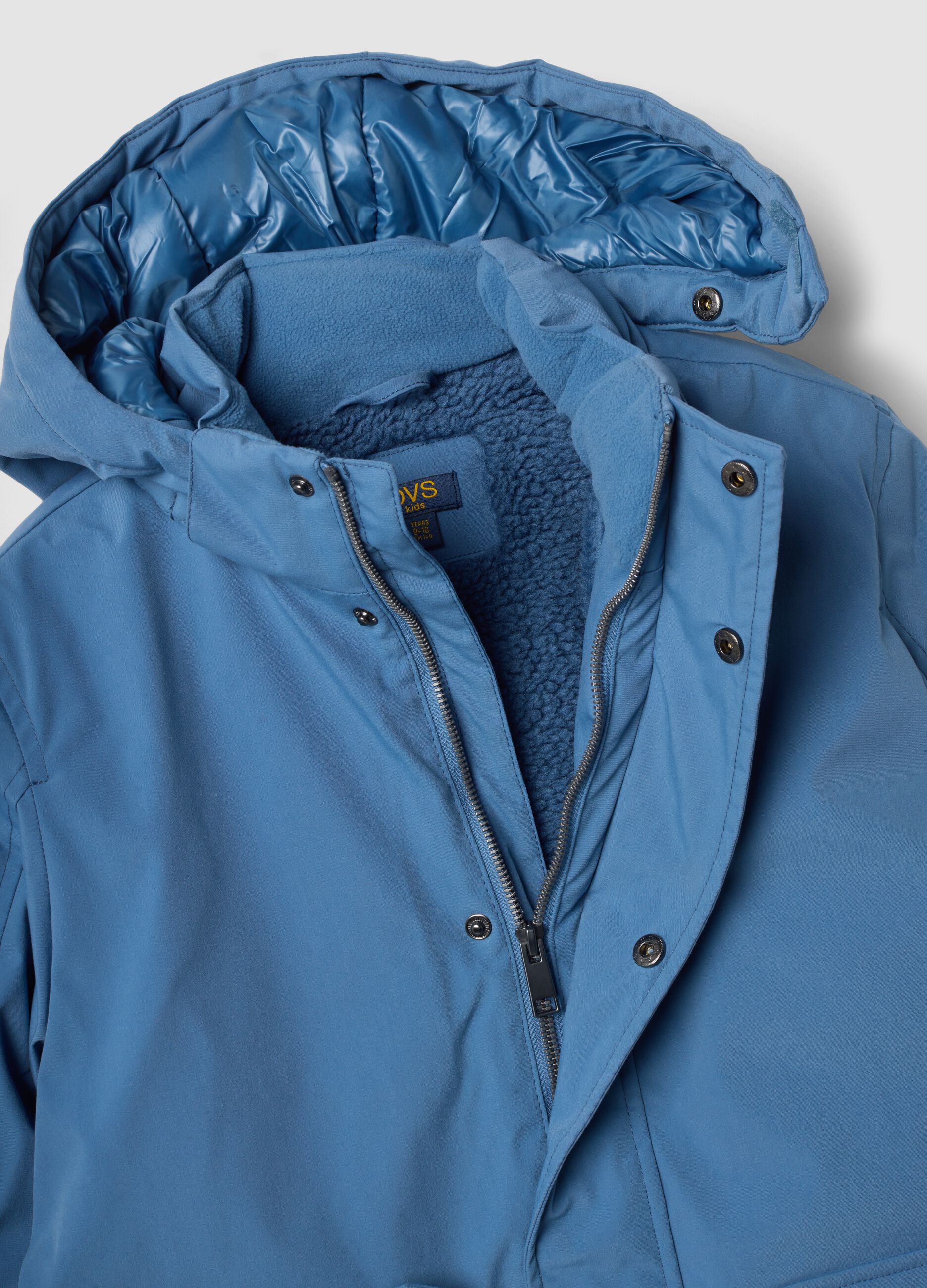 Long padded blue parka with detachable hood, oversized fit