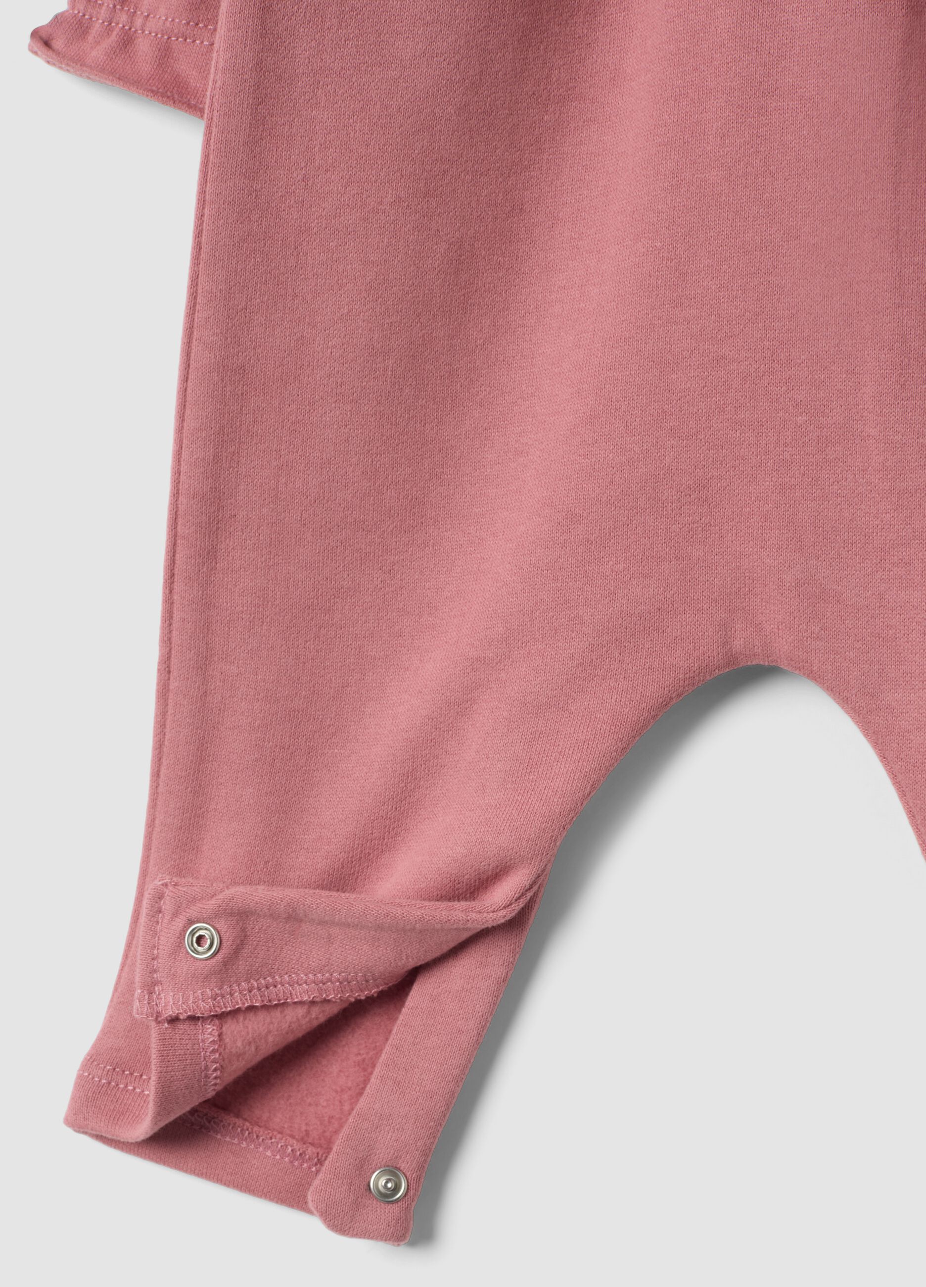 Pink organic cotton sleepsuit with ruffles and chest embroidery