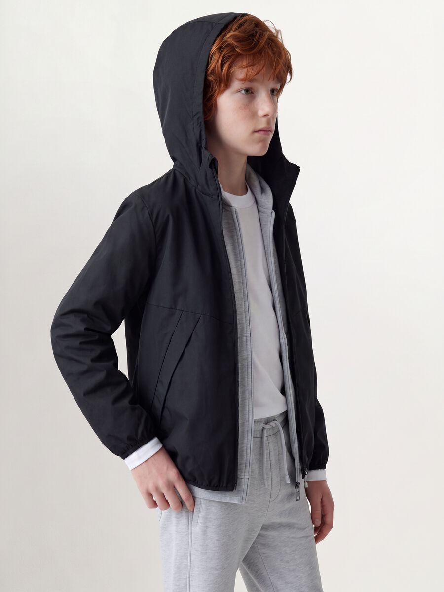 Black oversized rain jacket with hood and zip for boys_0
