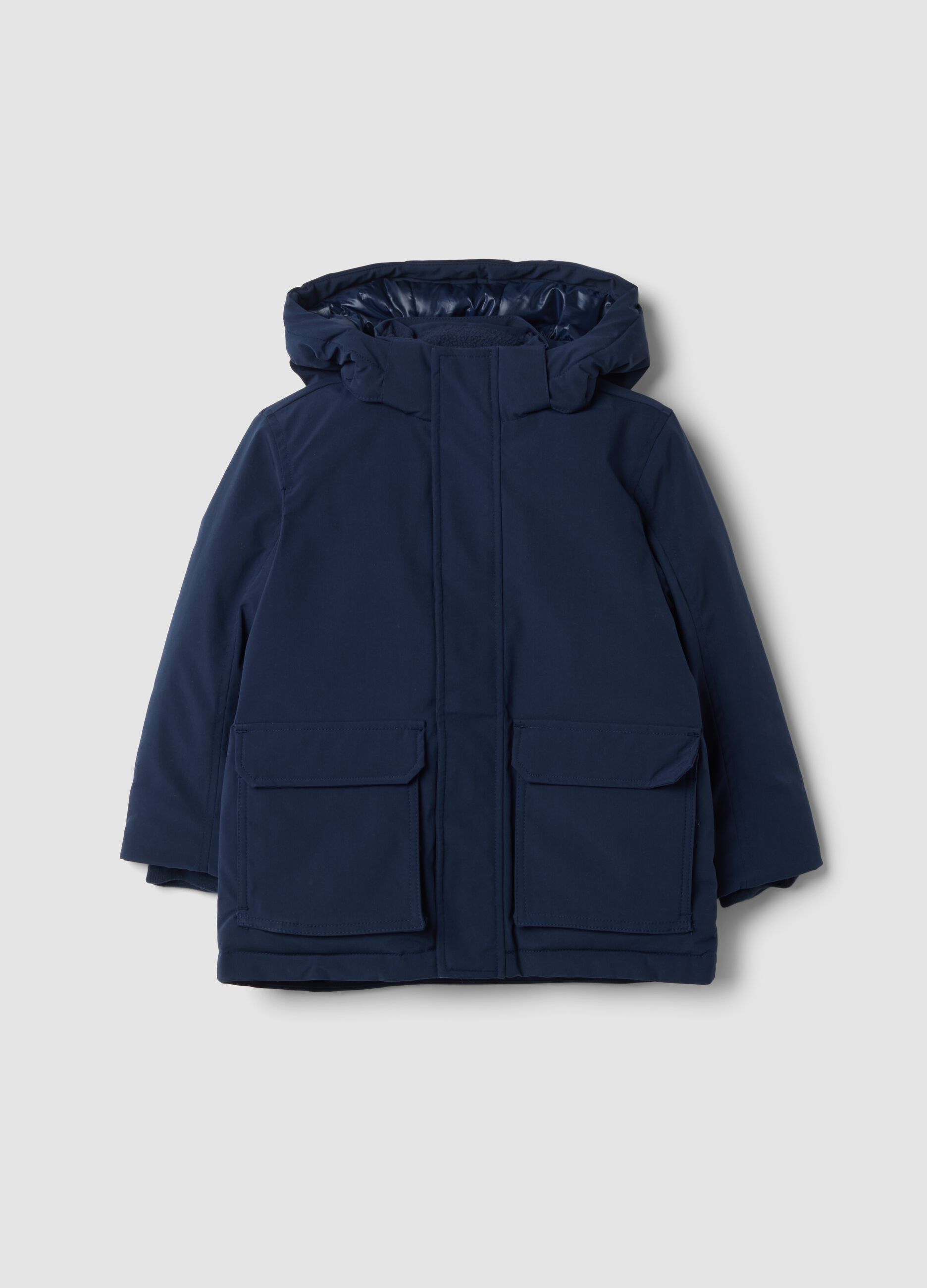 Long padded navy parka with detachable hood, oversized fit