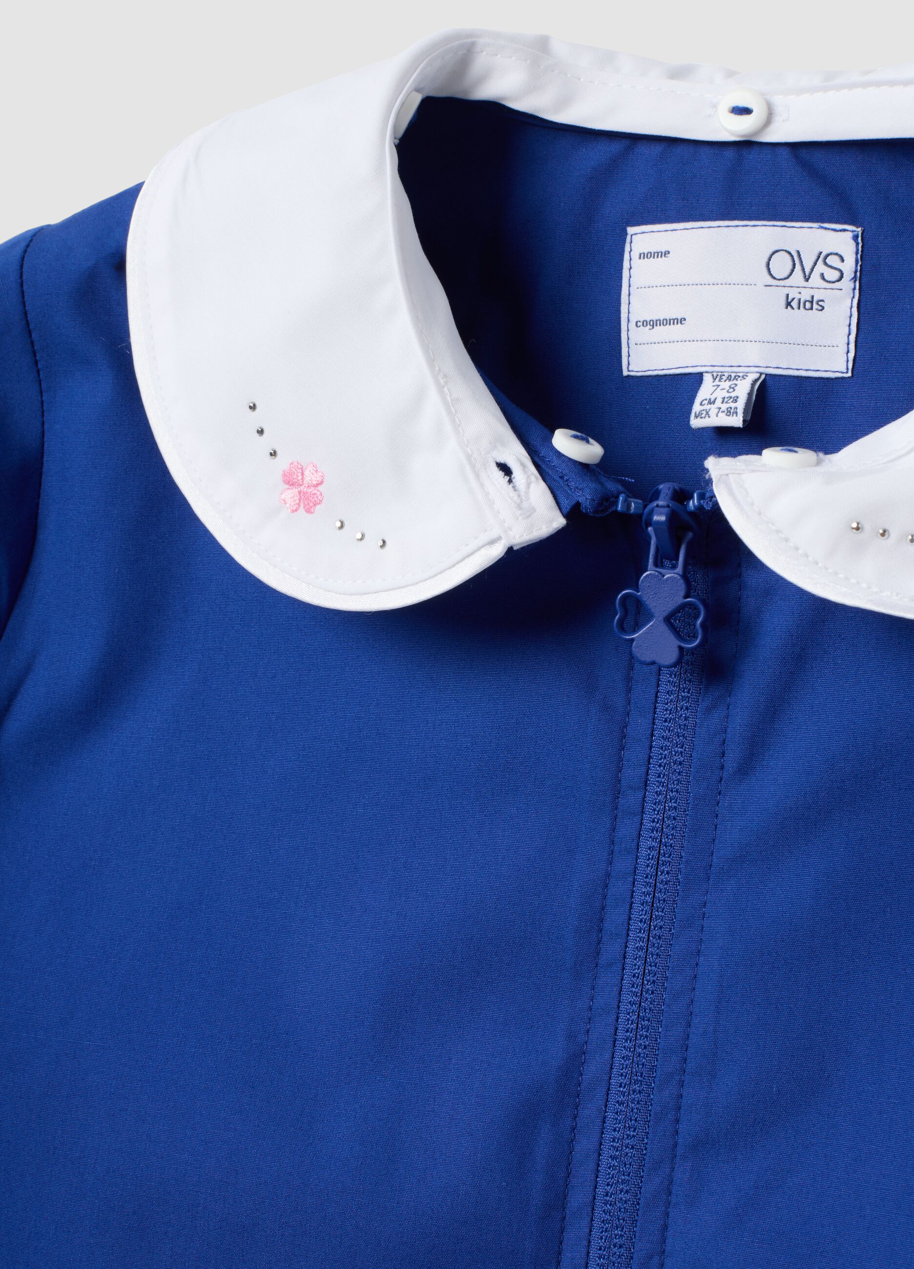 Customisable blue school apron with rhinestone details and floral embroidery